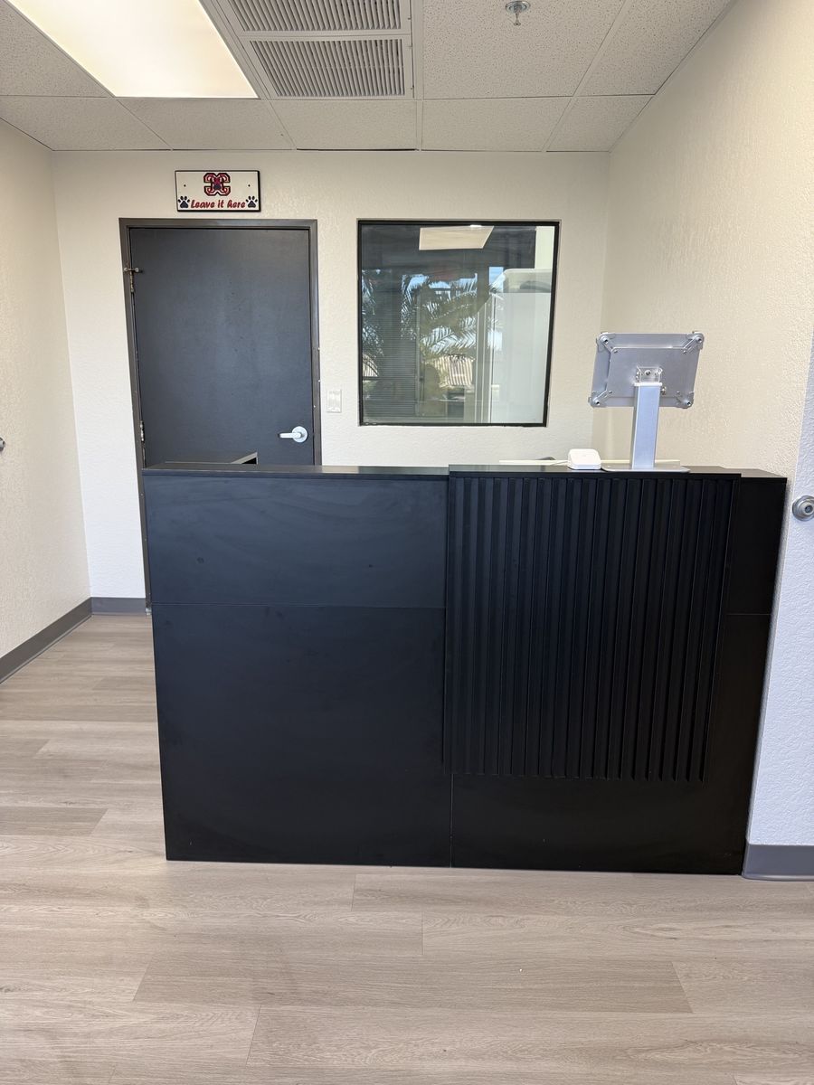 Black check-in counter with tablet stand in the entry, CheerCats tenant improvement, Henderson NV