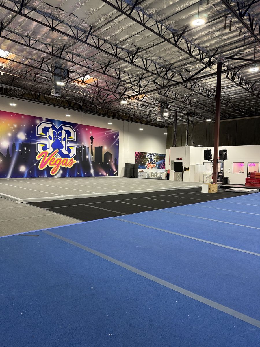 Blue competition floor and mural under exposed roof structure, CheerCats tenant improvement, Henderson NV