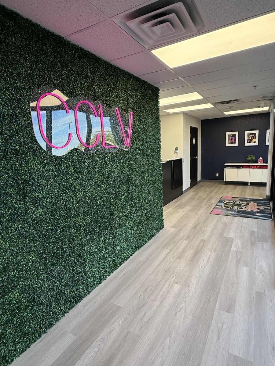Hallway with a green living-wall feature and neon logo sign, CheerCats tenant improvement, Henderson NV