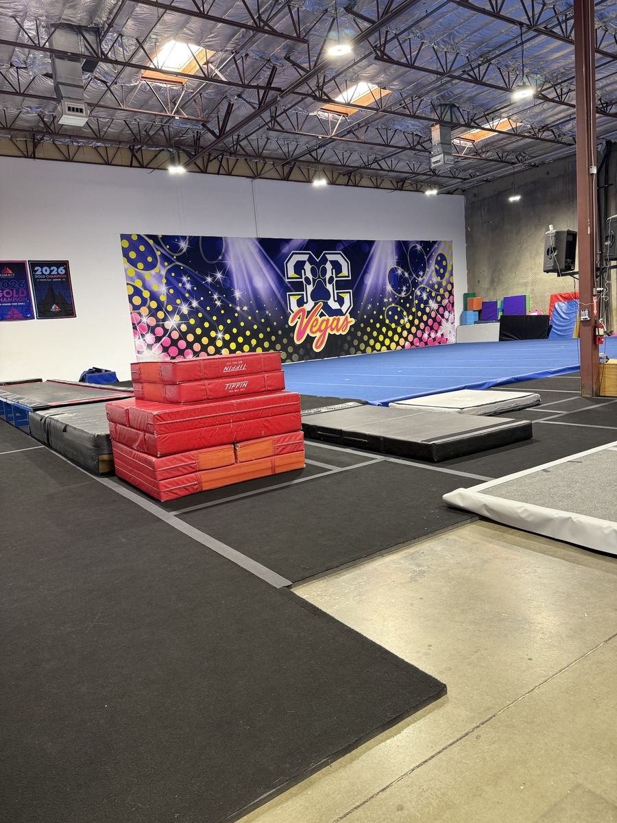 Gym floor with training mats and a large cheer mural under exposed roof structure, CheerCats tenant improvement, Henderson NV