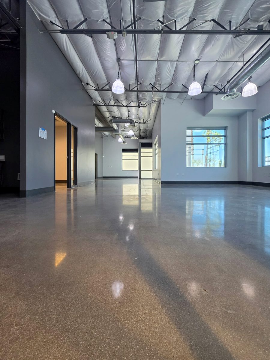 Office area with a polished concrete floor, pendant lights and exposed ductwork, CheerCats project, Henderson NV