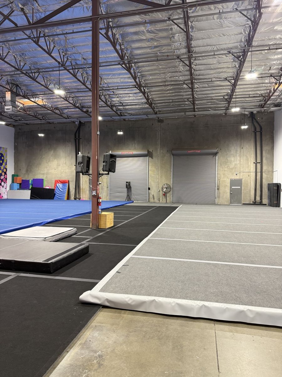Tumble track and gym floor near a roll-up door, CheerCats tenant improvement, Henderson NV